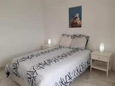 a small kitchen with a microwave and a refrigerator at Vista Praia 16- Wifi, Remodelado, 80mt Praia in Quarteira