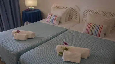 a bedroom with two beds with towels on them at FLOR DO VALE - APARTAMENTOS TURISTICOS in Guia
