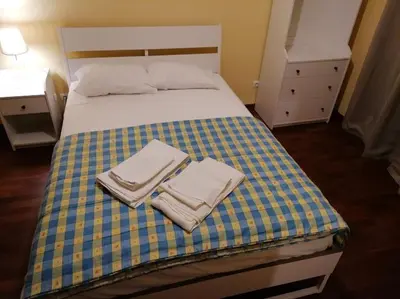 a bedroom with a bed with two towels on it at Minha casa in Faro