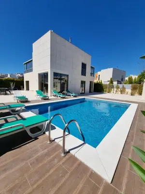 a swimming pool in front of a house at Luxury city Villa Olivia 10 - 15 min to the Beach Oura, private swimming pool in Albufeira