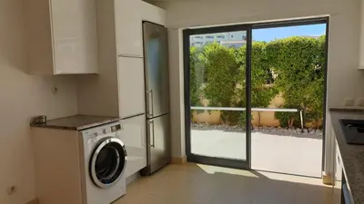 a kitchen with a washing machine and a window at Luxury city Villa Olivia 10 - 15 min to the Beach Oura, private swimming pool in Albufeira