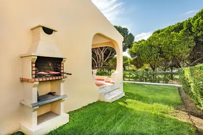 a living room with a couch and a table at Old Village Area and close to all amenities, Overlooking Golf Course in Quarteira