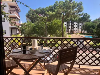 a table and chairs on a balcony with a view at Praia da Falésia - Falesia Beach - Apartment Pine Sun Park in Albufeira