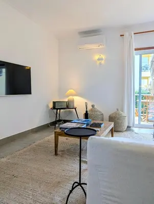 a resort with a pool with chairs and umbrellas at 1A The Apartment in Albufeira