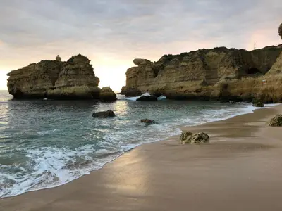 a beach with some rocks in the water at Appartement Sao Rafael praia Algarve portugal in Albufeira
