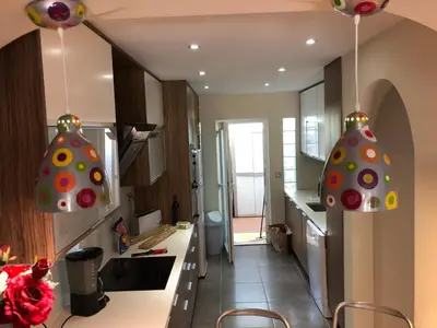 a kitchen with two pendant lights hanging from the ceiling at Appartement Sao Rafael praia Algarve portugal in Albufeira