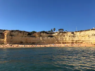 a group of people on a beach near the water at Appartement Sao Rafael praia Algarve portugal in Albufeira