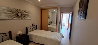 a bedroom with two beds and a bathroom at Encosta S. José -Vale Parra in Albufeira