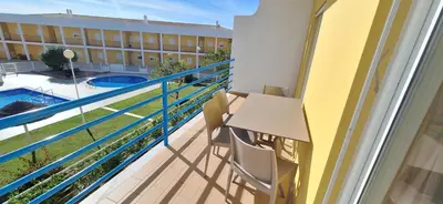 a balcony of a building with a swimming pool at Encosta S. José -Vale Parra in Albufeira