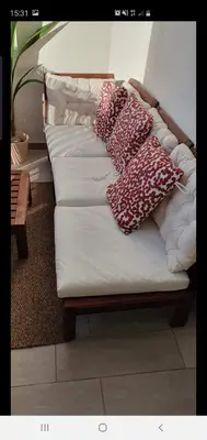 a couch with four pillows on it in a room at Vila Magna Albufeira in Albufeira