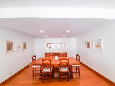 a dining room with a wooden table and chairs at Por do Sol Dourado T2 HsR Vilamarina in Vilamoura