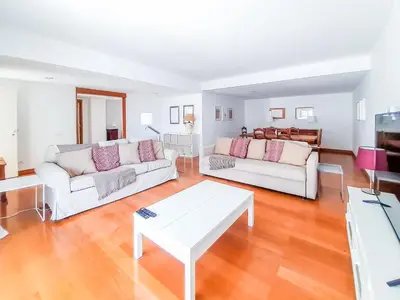 a living room with two white couches and a table at Por do Sol Dourado T2 HsR Vilamarina in Vilamoura