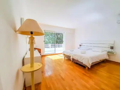 a bedroom with a bed and a lamp on a wooden floor at Por do Sol Dourado T2 HsR Vilamarina in Vilamoura