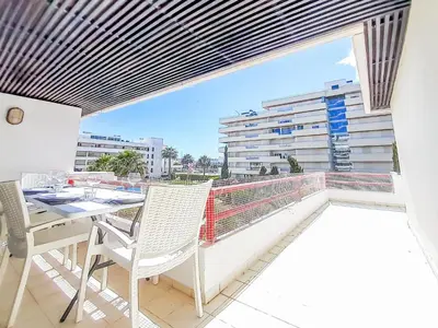 a balcony with a table and chairs and a view at Por do Sol Dourado T2 HsR Vilamarina in Vilamoura