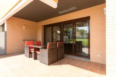 a patio with chairs and a table on a house at Apartamento Monte Laguna in Vilamoura