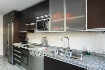 a kitchen with a sink and a microwave at Apartamento Monte Laguna in Vilamoura
