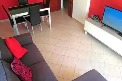 a living room with a couch and a table at Falesia - near the beach - The GAVEL Apartment in Albufeira