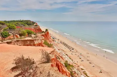 a beach with a bunch of people on it at Falesia - near the beach - The GAVEL Apartment in Albufeira