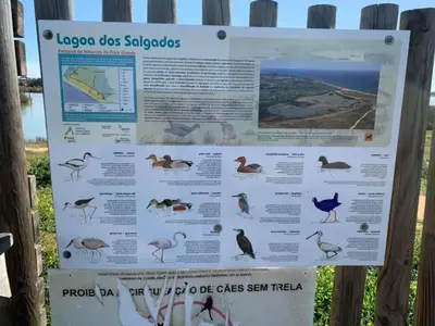 a sign for a beach with birds on it at Salgados Beach and Relax in Guia