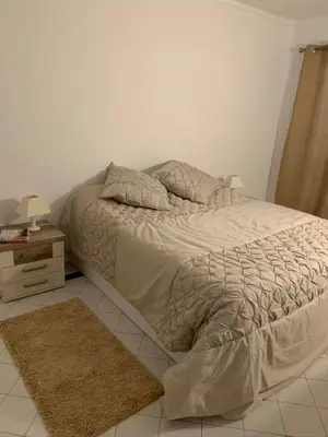a large bed in a bedroom with a nightstand and a bed sidx sidx sidx at Salgados Beach and Relax in Guia