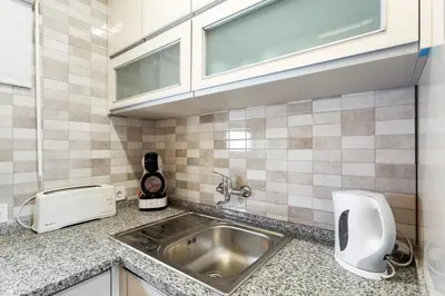a kitchen counter with a sink and a window at Elma By Albufeira Rental in Albufeira