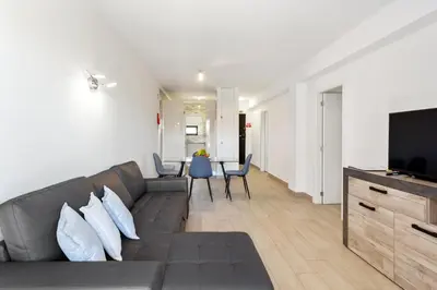 a living room with a couch and a flat screen tv at Elma By Albufeira Rental in Albufeira