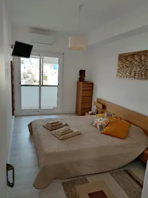 a bedroom with a bed with towels on it at Milu house in Faro