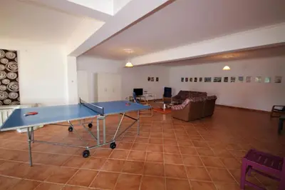 a large room with a ping pong table in it at Villa Olive in Loulé