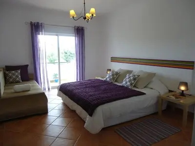 a bedroom with a large bed and a window at Villa Olive in Loulé