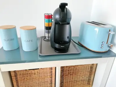 a coffee maker on a table with other appliances at Mira Praia, Sunny and Sea in Quarteira