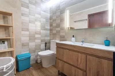 a bathroom with a sink and a toilet at Holiday house in elite residential area of Faro in Faro