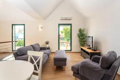 a living room with couches and a flat screen tv at Holiday house in elite residential area of Faro in Faro