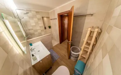 a small bathroom with a sink and a shower at Holiday house in elite residential area of Faro in Faro
