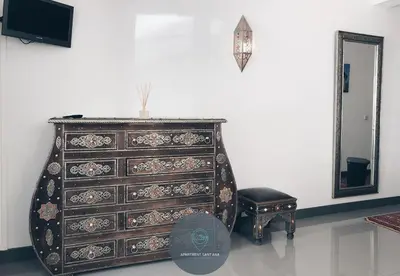 a dresser in a room with a mirror and a stool at Apartment Sant'Ana Old Town Albufeira - Bay View in Albufeira