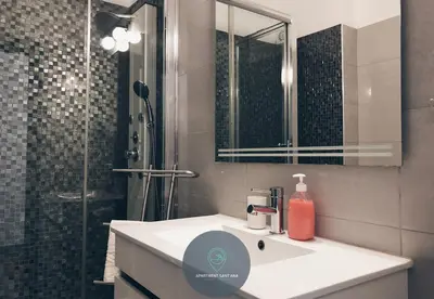 a bathroom with a sink and a shower with a mirror at Apartment Sant'Ana Old Town Albufeira - Bay View in Albufeira