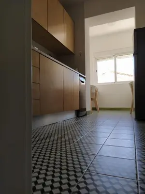 a kitchen with a black and white tile floor at Urban Apartment in Faro