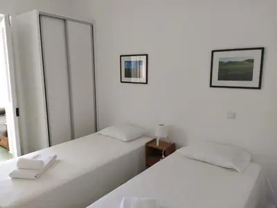 two beds sitting next to each other in a bedroom at Urban Apartment in Faro