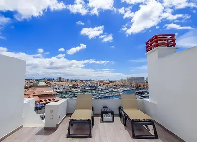 a balcony with chairs and a view of a harbor at Penthouse Triplex L25 T2 by HsR Vilamarina in Vilamoura
