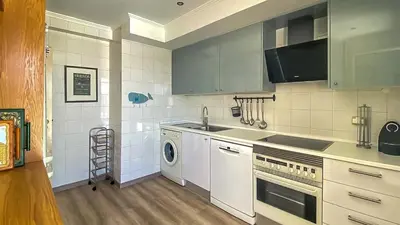 a kitchen with a sink and a washing machine at Penthouse Triplex L25 T2 by HsR Vilamarina in Vilamoura