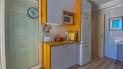 a kitchen with a white refrigerator and a microwave at Penthouse Triplex L25 T2 by HsR Vilamarina in Vilamoura