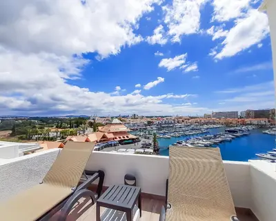 a balcony with chairs and a view of a marina at Penthouse Triplex L25 T2 by HsR Vilamarina in Vilamoura