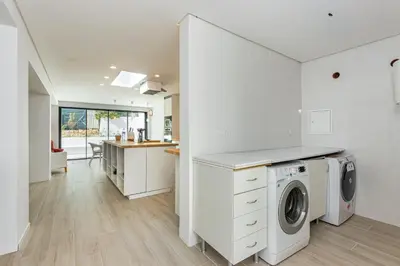 a white laundry room with a washer and dryer at Villa AL Fresco in Guia