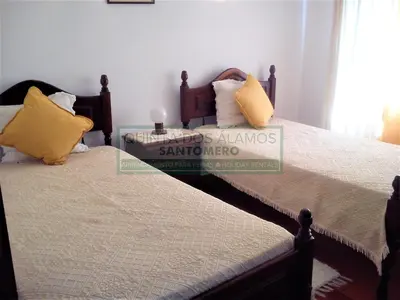 two beds sitting next to each other in a bedroom at Villa Catuna - Quinta do Jolu in Guia