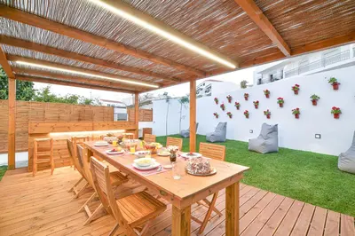 a patio with a wooden table and chairs at Elevator's Beach House by Atlantic Places in Albufeira