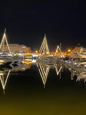 a bridge over a body of water at night at Villa CHELSEA in Vilamoura