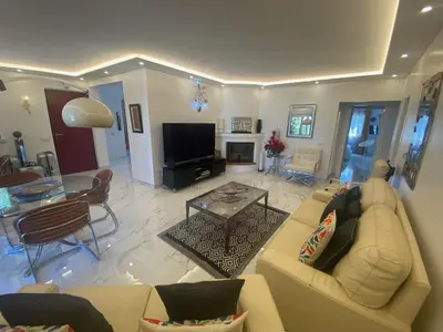 a living room with a couch and a table at Villa CHELSEA in Vilamoura