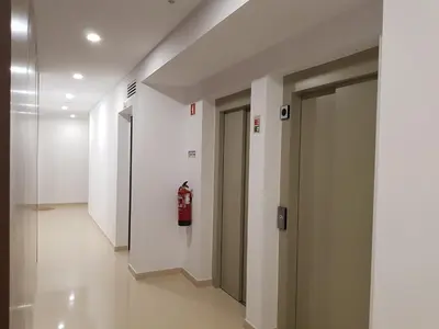 a hallway with a fire hydrant in a building at Alto do Forte Novo- Ar- Condicionado, Wifi, Vista Mar in Quarteira