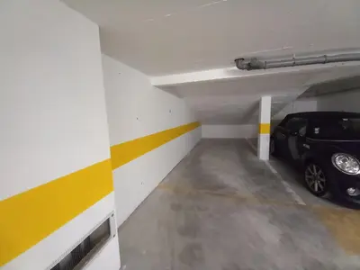 a parking garage with a car parked in it at Alto do Forte Novo- Ar- Condicionado, Wifi, Vista Mar in Quarteira