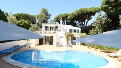 a swimming pool in front of a house at Beautiful Portuguese Villa Casa Das Buganvillas 3 Bedrooms Close To Praca in Vale do Lobo