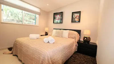 a bedroom with a bed and a large window at Beautiful Portuguese Villa Casa Das Buganvillas 3 Bedrooms Close To Praca in Vale do Lobo